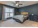 Comfortable bedroom with soft natural light, a ceiling fan, and neutral walls and carpet at 1708 Royal Gorge Ave, Charlotte, NC 28210
