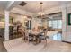 Elegant dining room featuring a modern chandelier, stylish furniture and view to kitchen and living area at 1708 Royal Gorge Ave, Charlotte, NC 28210