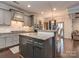 Spacious kitchen with gray cabinets, stainless steel appliances and island with granite countertops at 1708 Royal Gorge Ave, Charlotte, NC 28210