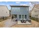 Landscaped backyard features a cozy patio, deck with dining set, and fenced perimeter at 1710 Woodward Ave, Charlotte, NC 28206