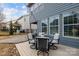 Charming backyard deck features a dining table set and string lights for evening ambiance at 1710 Woodward Ave, Charlotte, NC 28206