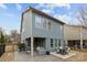 Backyard view shows the covered patio, a deck with outdoor dining, and privacy fence at 1710 Woodward Ave, Charlotte, NC 28206