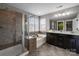 Well-lit bathroom featuring a glass shower, a soaking tub, and dual vanity at 1710 Woodward Ave, Charlotte, NC 28206