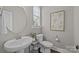 Bright half-bathroom features a pedestal sink and lovely decor at 1710 Woodward Ave, Charlotte, NC 28206