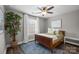 Well-lit bedroom features a cozy atmosphere with a ceiling fan and large plant at 1710 Woodward Ave, Charlotte, NC 28206