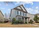 Stylish home showcasing well-maintained lawn, mature trees, and classic architectural design at 1710 Woodward Ave, Charlotte, NC 28206