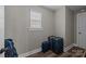 Hallway with a window, dark wood floors, gray walls and three pieces of luggage at 1710 Woodward Ave, Charlotte, NC 28206