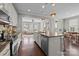 Open kitchen with granite countertops and a large island transitions to a sunny living room at 1710 Woodward Ave, Charlotte, NC 28206