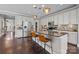 Modern kitchen with stainless steel appliances, large island with seating and stylish pendant lighting at 1710 Woodward Ave, Charlotte, NC 28206