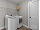 Functional laundry room featuring modern washer and dryer units and ample storage space at 1710 Woodward Ave, Charlotte, NC 28206