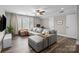 Spacious living room boasts a large gray sectional, dark wood floors, and plenty of natural light at 1710 Woodward Ave, Charlotte, NC 28206