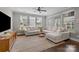 Spacious living room with a large comfortable sectional sofa, fan and lots of natural light at 1710 Woodward Ave, Charlotte, NC 28206