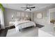 A cozy and well-lit main bedroom featuring a modern ceiling fan and minimalist decor at 1710 Woodward Ave, Charlotte, NC 28206