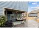Cozy covered patio with ample seating, grill, and outdoor TV at 1710 Woodward Ave, Charlotte, NC 28206