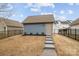 Exterior view of a backyard shed with concrete steps and secure fencing at 1710 Woodward Ave, Charlotte, NC 28206