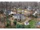 Aerial view of home showcasing roof, backyard with trees, shed, and surrounding neighborhood at 1715 Shagbark Ln, Charlotte, NC 28226