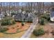 Aerial view of a single-story home with mature trees, manicured landscaping and long driveway at 1715 Shagbark Ln, Charlotte, NC 28226