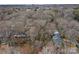 Distant aerial view of property and neighborhood filled with trees at 1715 Shagbark Ln, Charlotte, NC 28226