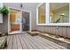Wooden back patio area with flower boxes and views into kitchen and upper floor windows at 1715 Shagbark Ln, Charlotte, NC 28226
