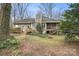 Backyard featuring a patio, stairs, and mature trees at 1715 Shagbark Ln, Charlotte, NC 28226