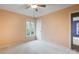This bedroom has a ceiling fan, and a window overlooking the surrounding foliage at 1715 Shagbark Ln, Charlotte, NC 28226