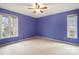 The bedroom features two windows, a ceiling fan and painted walls at 1715 Shagbark Ln, Charlotte, NC 28226