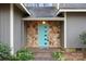 Close up view of stone facade and light blue front door with modern design elements at 1715 Shagbark Ln, Charlotte, NC 28226