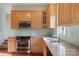 The kitchen has stainless steel appliances, wooden cabinets, and granite countertops at 1715 Shagbark Ln, Charlotte, NC 28226