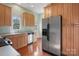 This kitchen has stainless steel appliances, wooden cabinets, and a stainless steel refrigerator at 1715 Shagbark Ln, Charlotte, NC 28226