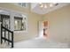 Living room with stairs and chandelier overlooking kitchen and back patio at 1715 Shagbark Ln, Charlotte, NC 28226