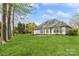 Expansive backyard featuring lush green grass and patio leading to the back of the house at 2019 W Laporte Dr, Charlotte, NC 28216