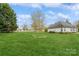 Spacious backyard with a sprawling lawn and mature trees offering privacy at 2019 W Laporte Dr, Charlotte, NC 28216