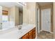 Bathroom features a vanity with drawers, a large mirror, tile flooring and a tub with shower at 2019 W Laporte Dr, Charlotte, NC 28216