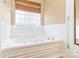 The bathroom includes a whirlpool tub with jets and tiled walls at 2019 W Laporte Dr, Charlotte, NC 28216