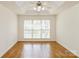 Spacious bedroom with hardwood floors, neutral walls and a tray ceiling at 2019 W Laporte Dr, Charlotte, NC 28216