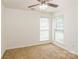 Bright bedroom featuring neutral paint, carpet, and two windows providing natural light at 2019 W Laporte Dr, Charlotte, NC 28216