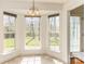 Cozy breakfast nook filled with sunlight from multiple windows offering serene views of the outdoors at 2019 W Laporte Dr, Charlotte, NC 28216
