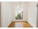Elegant dining room with hardwood floors, large window and stylish chandelier at 2019 W Laporte Dr, Charlotte, NC 28216