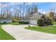 Spacious home exterior with garage, outbuilding, and long driveway leading to ample parking at 2019 W Laporte Dr, Charlotte, NC 28216