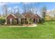 Charming brick home with lush green lawn, inviting curb appeal, and mature landscaping at 2019 W Laporte Dr, Charlotte, NC 28216