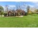 Inviting brick home with lush green lawn and beautiful landscaping enhancing curb appeal at 2019 W Laporte Dr, Charlotte, NC 28216