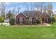 Lovely brick home with well-manicured lawn, complemented by lush landscaping and mature trees at 2019 W Laporte Dr, Charlotte, NC 28216