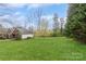 Expansive front yard showcases a green lawn and mature trees on a sunny day at 2019 W Laporte Dr, Charlotte, NC 28216