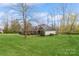 Well-maintained home with a lush lawn, mature trees, and manicured landscaping at 2019 W Laporte Dr, Charlotte, NC 28216