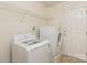 Functional laundry room with modern appliances, shelving, and exterior access at 2019 W Laporte Dr, Charlotte, NC 28216