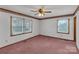 Bright bedroom featuring neutral walls, pink carpet, and two windows with outside views at 218 Countryside Rd, Kings Mountain, NC 28086