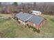 Aerial perspective displaying a house with a cozy front porch, well-kept garden and a detached garage at 218 Countryside Rd, Kings Mountain, NC 28086