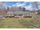 Aerial view of the brick home, showcasing the manicured lawn, landscaping, and covered front porch at 218 Countryside Rd, Kings Mountain, NC 28086