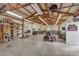 Open garage featuring a riding lawn mower, tool bench, and storage shelves at 218 Countryside Rd, Kings Mountain, NC 28086