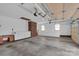 Clean garage boasting smooth concrete floors, brick accent wall, and white base cabinets for storage at 218 Countryside Rd, Kings Mountain, NC 28086
